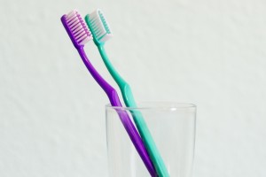 Two toothbrushes in a jar