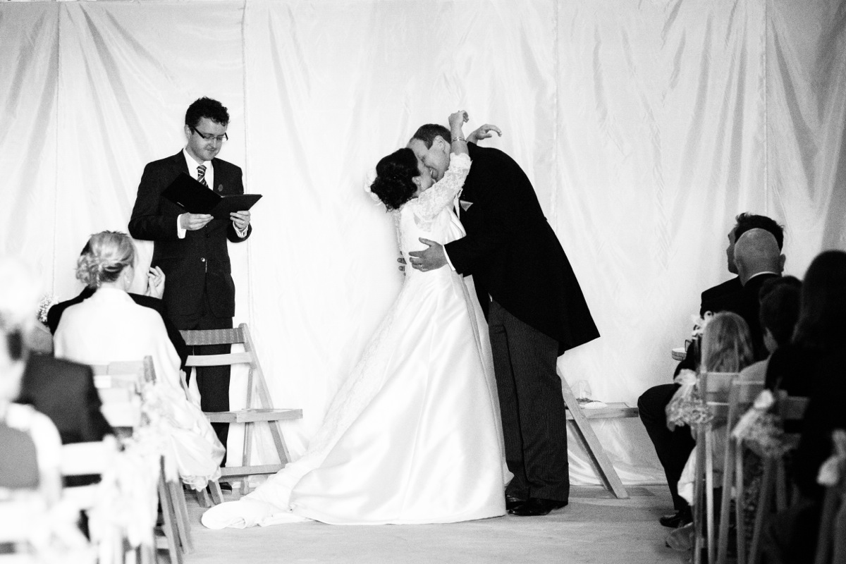 Kate and David kiss at the end of their wedding ceremony