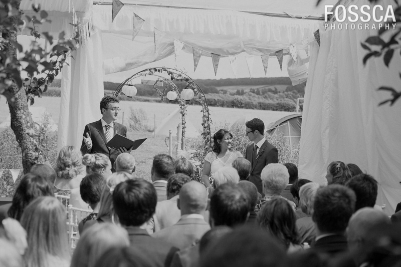 Black and white photo of the guests, the groom, the bride and the celebrant