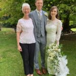 A groom flanked by his bride and their humanist wedding celebrant in Somerset