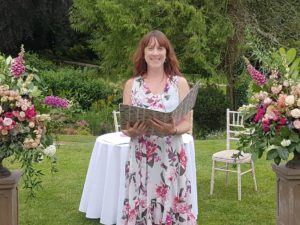 Picture of Maria Thorne Wedding Celebrant at an outdoor ceremony, surrounded by flowers