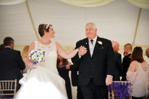 Humanist Wedding, Bride looking at Groom holding hands